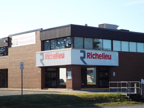 Ottawa, ON, Canada-July 7,2025: The 940 Belfast Office Centre features "Richelieu hardware" signage and a banner for the Toronto Truck Driving School.
