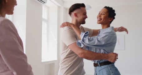 Real estate agent giving keys to family couple and congratulating with buying new property. Cheerful husband and wife giving high five, happy to buy new apartment for living. Property purchase