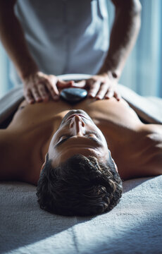 Terapia con piedras calientes que evoca apertura emocional, relajaci&oacute;n profunda y conexi&oacute;n energ&eacute;tica en un ambiente de spa. Una persona, con los ojos cerrados, recibe una piedra caliente en el pecho 