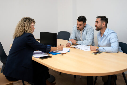 Lawyer advising gay couple during legal consultation