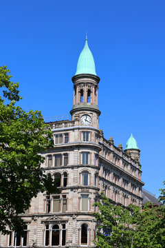 BELFAST NORTHERN IRELAND UNITED KINGDOM. Green copper ogee dome and tower clock on old Robinson and Cleavers department store in belfast designed by Young and Mackenzie