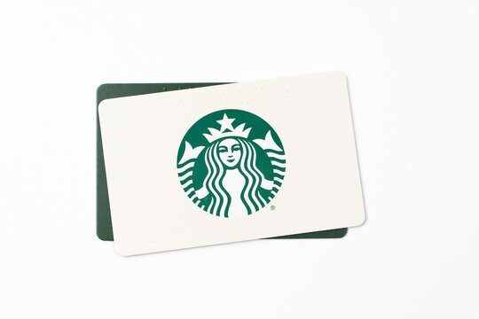 Detroit, Michigan, USA - 18 Jan 2026 : Minimalist studio photo of two Starbucks gift cards featuring the iconic green siren logo.