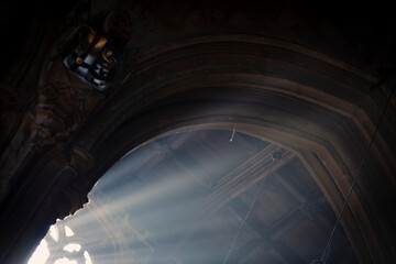 Interior scene of an ancient Gothic Cathedral architecture with rays of light crossing the roof space