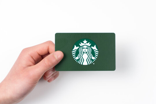 Detroit, Michigan, USA - 18 Jan 2026 : Hand hold of a green Starbucks gift cards featuring the iconic green siren logo.