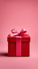 Elegant Red Gift Box with Pink Ribbon on Soft Background
