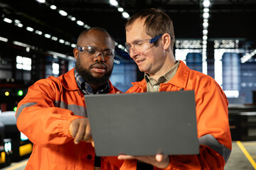 Engineers team coordinates strong labor in industry plant with gadgets, demonstrating engineering...