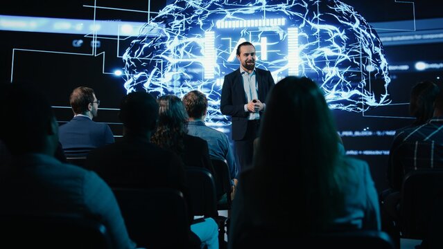 AI-powered business pitch with data science and artificial intelligence features. Public speaker explains investing strategy and funding opportunities to mixed age audience. - Powered by Adobe