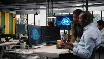 Data scientists doing brainstorming in office, using specialized hardware to accelerate complex AI calculations. IT professionals collaborating, managing deep learning datasets systems, camera A