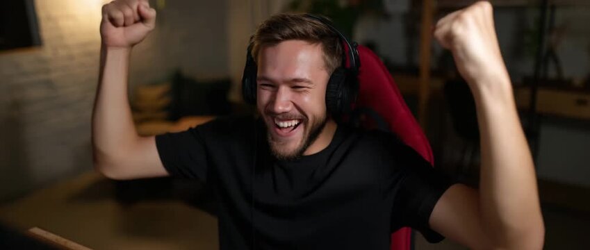 A gamer shows joy after winning a video game match.