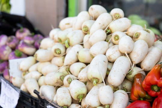 High quality imported eco rutabaga are grouped stored in window in wicker basket. From producers farmer to consumers table. Design of showcase of vegetable store, positioning of goods
