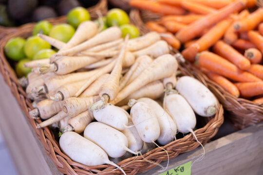 Lot of high quality organic Swedish turnip is laid out on shop window. Various varieties of harvest vegetables are presented in greengrocers shop.