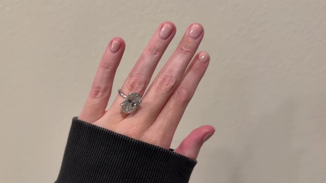 Large 9 carat oval diamond solitaire engagement ring filmed on a hand in a clean minimal setting.
