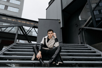 Young caucasian male in urban setting wearing stylish trench coat