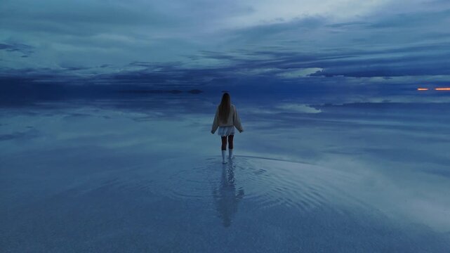 A tranquil early morning walk across the expansive Salar de Uyuni in Bolivia, capturing the serene beauty of the world's largest salt flat