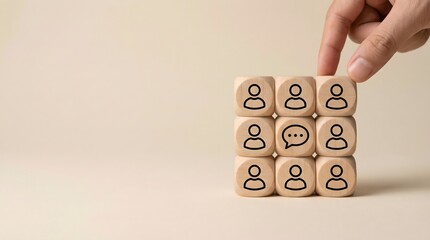 wooden blocks with people icons and hand
