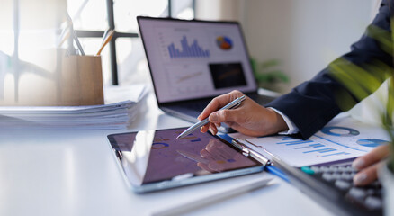 Business professional investor working new start up project. tablet laptop computer with digital marketing media in virtual icon design Finance managers meeting.
