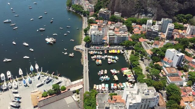 Aerial video showcases Urca neighborhood and Guanabara Bay in Rio de Janeiro, Brazil.