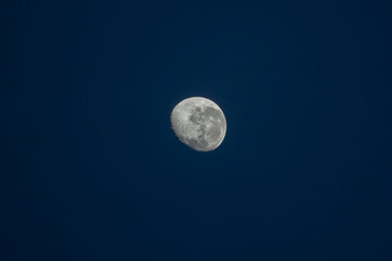 almost full moon over blue sky