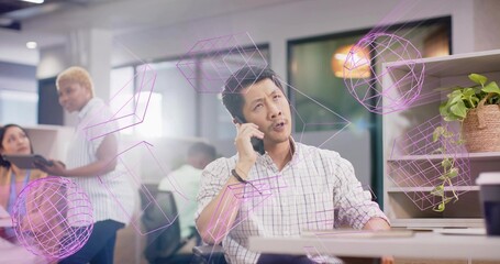 Speaking man wearing checked shirt holding smartphone at office with tablet and purple overlay
