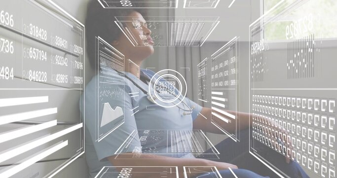 Monitoring female nurse studying holographic panels in clinic, in blue scrubs with stethoscope - Powered by Adobe