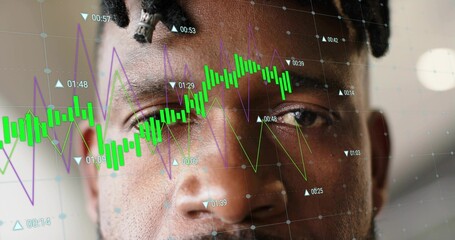 Staring mature African American man holding focused gaze in studio, with candlestick charts overlay