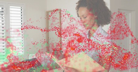 Holding woman wearing blouse reading tan folder at home with shutters and red-green overlay