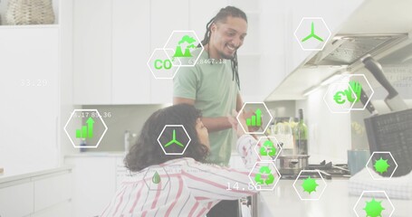 Cooking couple wearing casual attire stirring pot at modern kitchen stove, with tablet and AR icons