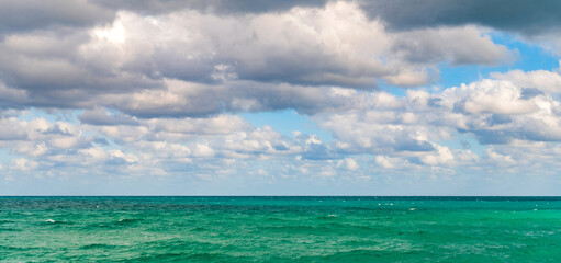 Fototapeta premium Skyscape with sea horizon. Calm horizon with sea nature. Romantic summer vacation at seascape. Sunset sea and seascape. Sea horizon view. Cloudy sky and seascape at summer vacation. Coastal paradise