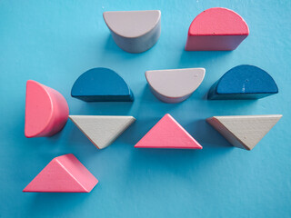 Minimalist Flat Lay of Colorful Wooden Geometric Blocks and Shapes on Bright Blue Background for Early Childhood Education and Creativity