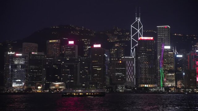 View of Hong Kong skyline and Star Ferry from Kowloon at night, Kowloon, Hong Kong, China, Asia