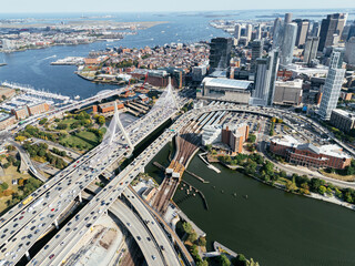 Fototapeta premium Aerial view of Boston skyline with Zakim Bridge, highways, Charles River and downtown cityscape on sunny day. g.