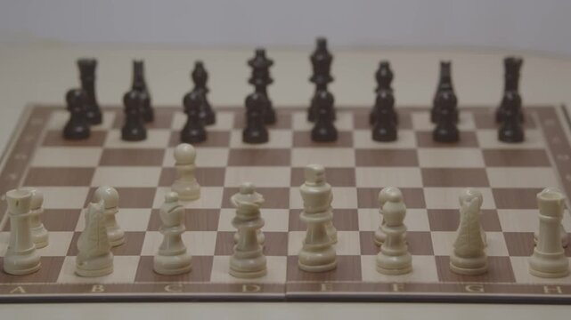 A cinematic shot of movement in a chess game. The first theoretical move is for White's pawn on c4