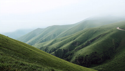 Obraz premium Verdant layered hills and valleys fade into mist