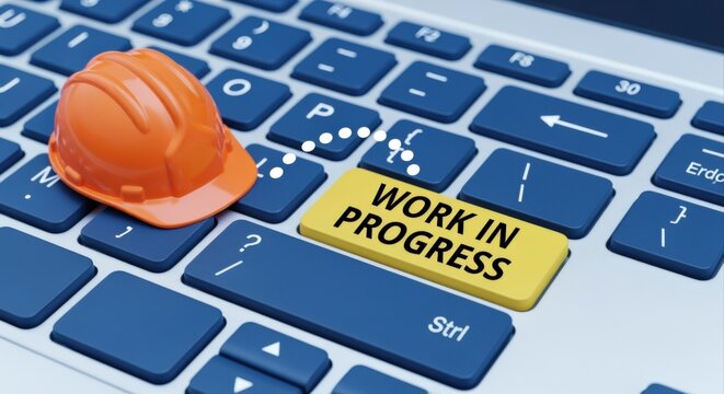 Under Construction: Orange Hard Hat on Computer Keyboard with Work In Progress Key