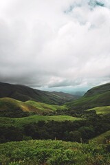 The pristine natural landscape features rolling hills and mist-shrouded mountains.