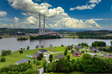 Air pollution from electric energy production from fossil fuel. Residential community homes near Kingston power station in Tennessee. Toxic emissions from coal-fired power plant producing electricity