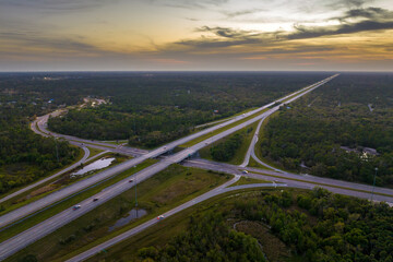 American highway bridge with fast moving traffic in evening. Interstate transportation concept