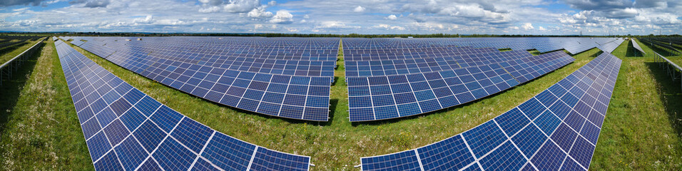 Aerial view of big sustainable electric power plant with many rows of solar photovoltaic panels for producing clean electrical energy. Renewable electricity with zero emission concept