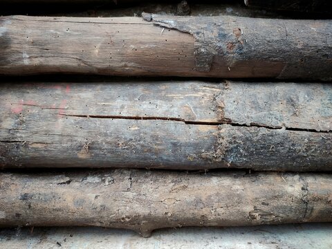 three old wooden beams stacked with natural texture and cracks