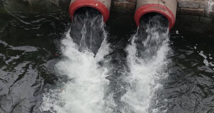 Pipes with water overflow at a reservoir dam