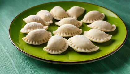 Freshly Made Uncooked Raw Lithuanian Traditional Cepelinai Made Of Potato Dough And Minced Ground Meat Inside On A Green Plate