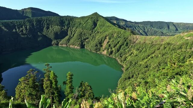 Scenic view over Lagoa Verde (Green Lake) surrounded by lush volcanic slopes at Sete Cidades, Sao Miguel Island, Azores, Portugal
