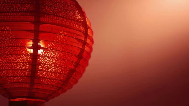 Red paper lantern glowing with ornate intricate pattern and warm ambient glow