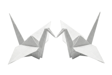Pair of white origami cranes touching beaks. Paper art concept.