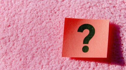 Paper question mark note on a pink textured surface for inquiry and help symbols, educational social media and branding concept image with copy space on the left