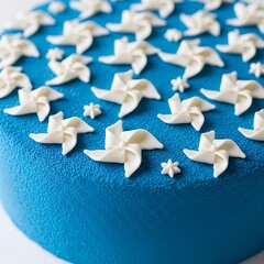 A vibrantly textured, azure blue cake is artfully decorated with delicate white fondant pinwheels