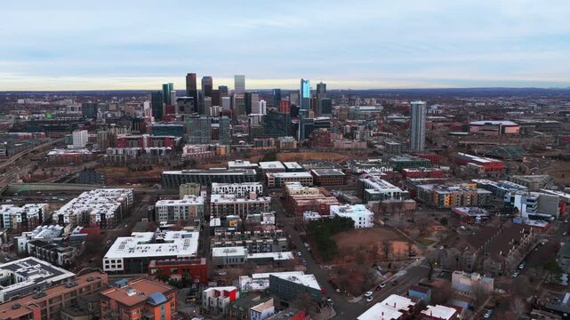 Downtown Denver Lodo skyline cityscape skyscrapers buildings winter Colorado aerial drone Highlands Park grey skies sunset interstate i25 traffic cars highway front range Rocky Mountains forward up