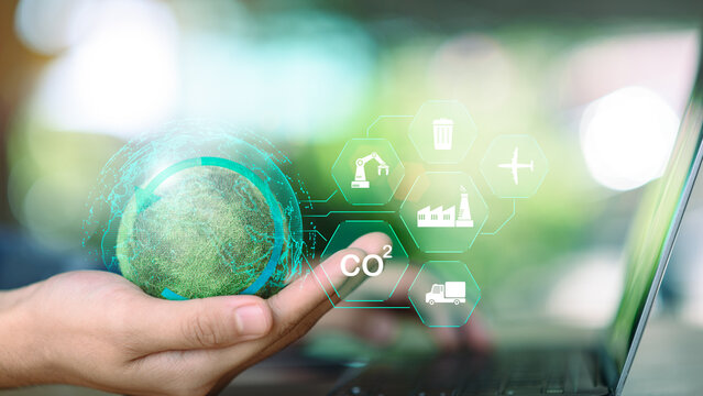 Sustainability manager managing global carbon footprint using digital technology and ESG industry icons. Concept of CO2 reduction, green supply chain, sustainable industry, circular economy - Powered by Adobe