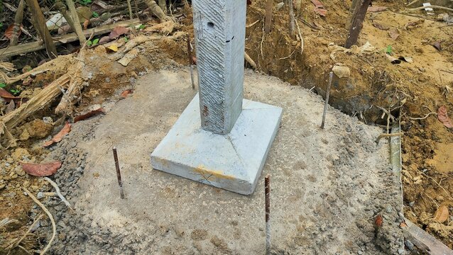 The base of the concrete pillars of the house that is ready to be erected. Pouring footing cement in square concrete formwork for foundation work. Deep Foundation Footing.