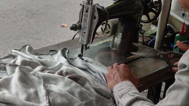 the hand sewing the textile neatly